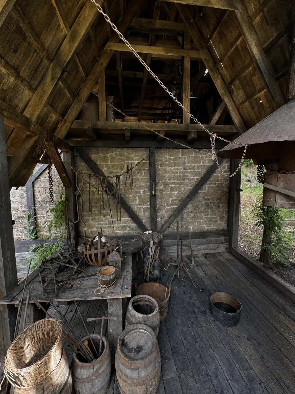 Working forge with period tools and stone walls